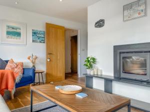 a living room with a couch and a table at The Lodge in Fowey