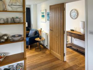 a room with a door and a table and a chair at The Lodge in Fowey