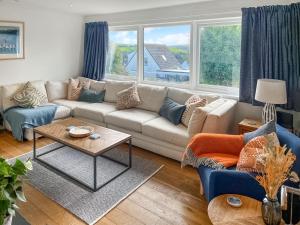 a living room with a couch and a table at The Lodge in Fowey