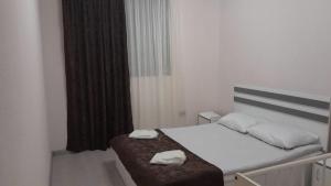 a bedroom with a bed with two towels on it at MM HOUSE Stepanavan in Stepʼanavan