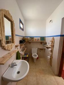 a bathroom with a sink and a toilet at Hippie Chic - Room La Dune in Sidi Kaouki