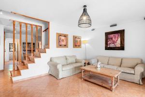 a living room with two couches and a table at MEDANO4YOU Montaña Roja Beach House in El Médano