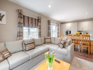 a living room with a couch and a table at Cherry Blossom - Uk48837 in Skegness