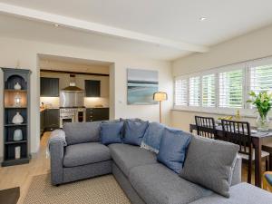 a living room with a couch and a dining room at Bluestone Cottage in Welton le Wold