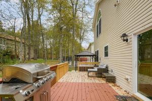 a backyard patio with a grill and a grill at Pocono Waterside Escape in Tobyhanna