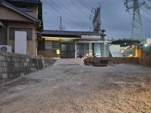 a house with a driveway in front of it at ゲストハウス若水黒崎 in Kitakyushu
