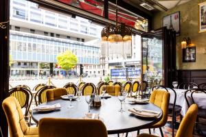 a table in a restaurant with a view of a street at ProfilHotels Central in Stockholm