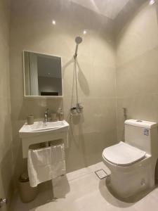 a bathroom with a toilet and a sink at Simple studio in Jeddah