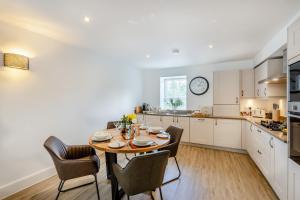 a kitchen and dining room with a table and chairs at Bronte House in Kirkby Lonsdale