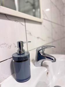 a bottle of nanking sitting on a bathroom sink at Cozy modern 2 bedroom apartment with comfortable lounge in Preston
