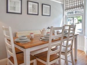 a dining room with a wooden table and chairs at Woodys in Windermere