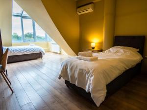a bedroom with two beds and a large window at Venti club B15 in Sofia