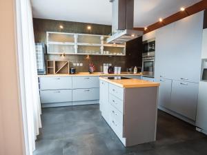 a kitchen with white cabinets and a brown counter top at Venti club B15 in Sofia
