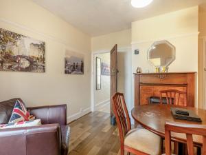 a living room with a dining room table and a couch at Trafalgar House in Gorleston-on-Sea