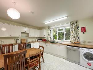 a kitchen with a table and a dining room at Croftfoot in Arnisdale