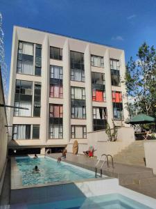 a large building with a swimming pool in front of it at Sukire in Ongata Rongai 