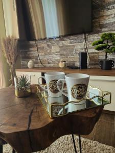 a tray of coffee cups on a wooden table at Magic Apartman Kop - Kraljevi Cardaci in Kopaonik