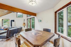 a dining room with a wooden table and chairs at Vail Meadows in Girdwood