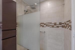 a shower with a glass door in a bathroom at Verodal 2 Bedroom Apartment in Los Cristianos