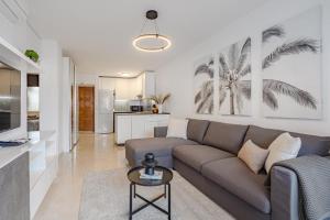 a living room with a couch and a kitchen at Verodal 2 Bedroom Apartment in Los Cristianos
