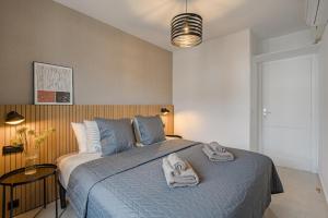 a bedroom with a bed with towels on it at Verodal 2 Bedroom Apartment in Los Cristianos