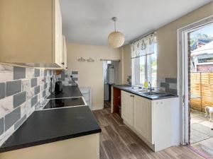 a kitchen with a sink and a counter top at Nursery Road Cottage in East Peckham +5 photos