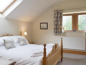 a bedroom with a bed and a window at The Old Dairy - Ukc3413 in Bolton by Bowland +9 photos