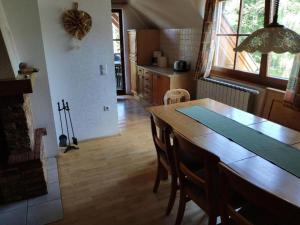 a kitchen with a wooden table and a dining room at Antela - large apartment 142m2 for 12 persons in Pohorje +9 photos