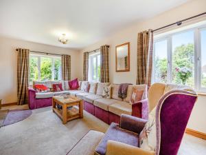 a living room with a couch and a table at The Nook in Chapel Saint Leonards