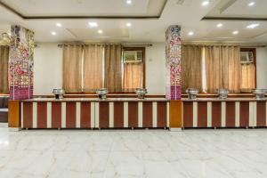 a large room with a stage and curtains at Treebo Basera in Mathura