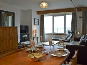 a living room with a table and a couch at Towan View in Newquay