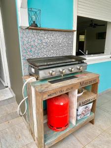 a kitchen with a stove and a red container at Villa Zandoli in Le Diamant