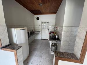 a kitchen with a refrigerator and a counter top at Casa Diamantina 3 in Diamantina