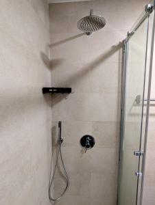 a shower in a bathroom with a glass door at Centro Coração in Tomar