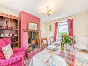 a living room with a table and a fireplace at Pennine View in Long Marton
