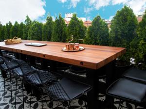 a table and chairs on a patio with trees at Tophane Suites in Istanbul