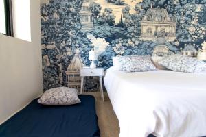 a bedroom with two beds and a wall mural at Vagator lux villas - Upernia in Anjuna