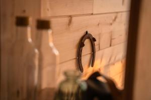 a pair of scissors hanging on a wall next to bottles at Homnest - L'Indiana Ranch - 20 min de Vichy in Espinasse-Vozelle