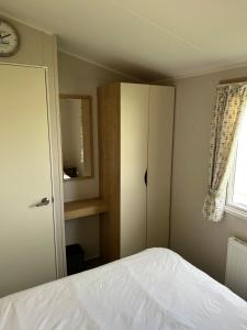 a bedroom with a bed and a cabinet and a window at Eyemouth getaway in Eyemouth