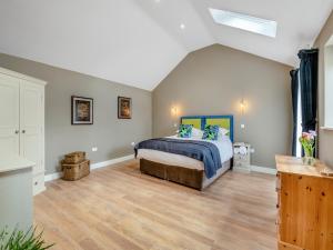 a bedroom with a bed and a wooden floor at Bracken At Holly House - Uk44469 in Newton +11 photos