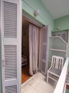 a room with a door and a chair in it at Hellen Guest House in Mesochórion +12 photos