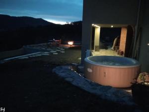 a large tub sitting outside of a building at night at Holiday Home in Bunjevci with Sauna & Garden in Vrbovsko +42 photos