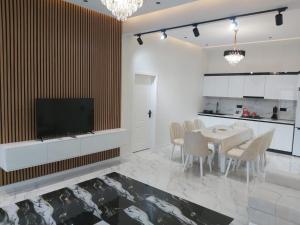a kitchen and dining room with a table and chairs at Quba Mountain View Villa with Heated Pool in Quba