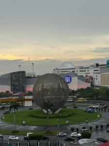 a large metal object in a parking lot in a city at 10th Floor Staycation in Manila +6 photos