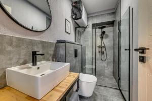a bathroom with a sink and a shower at La Shara Building in Sofia +17 photos