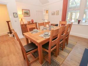a dining room with a wooden table and chairs at The Ives in Skipton
