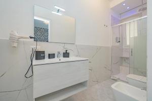 a white bathroom with a sink and a toilet at Round Room - 7 in Milan