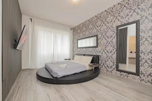 a bedroom with a large bed with a mirror at Round Room - 7 in Milan