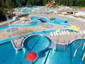 a view of a water park with a swimming pool at Caravan in the backyard in Šaľa