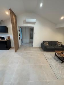 a living room with a couch and a table at Appartement moderne rénové et tout équipé in Givors